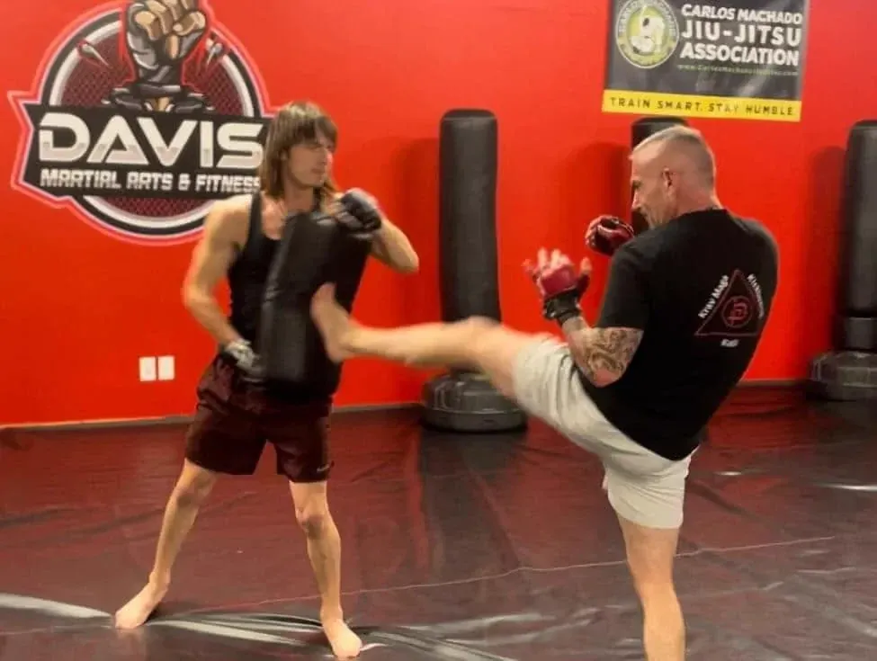 Adult Brazilian Jiu-Jitsu class watching a demonstration in Carlos Machado gis at Davis Martial Arts & Fitness in Pilot Point, TX
