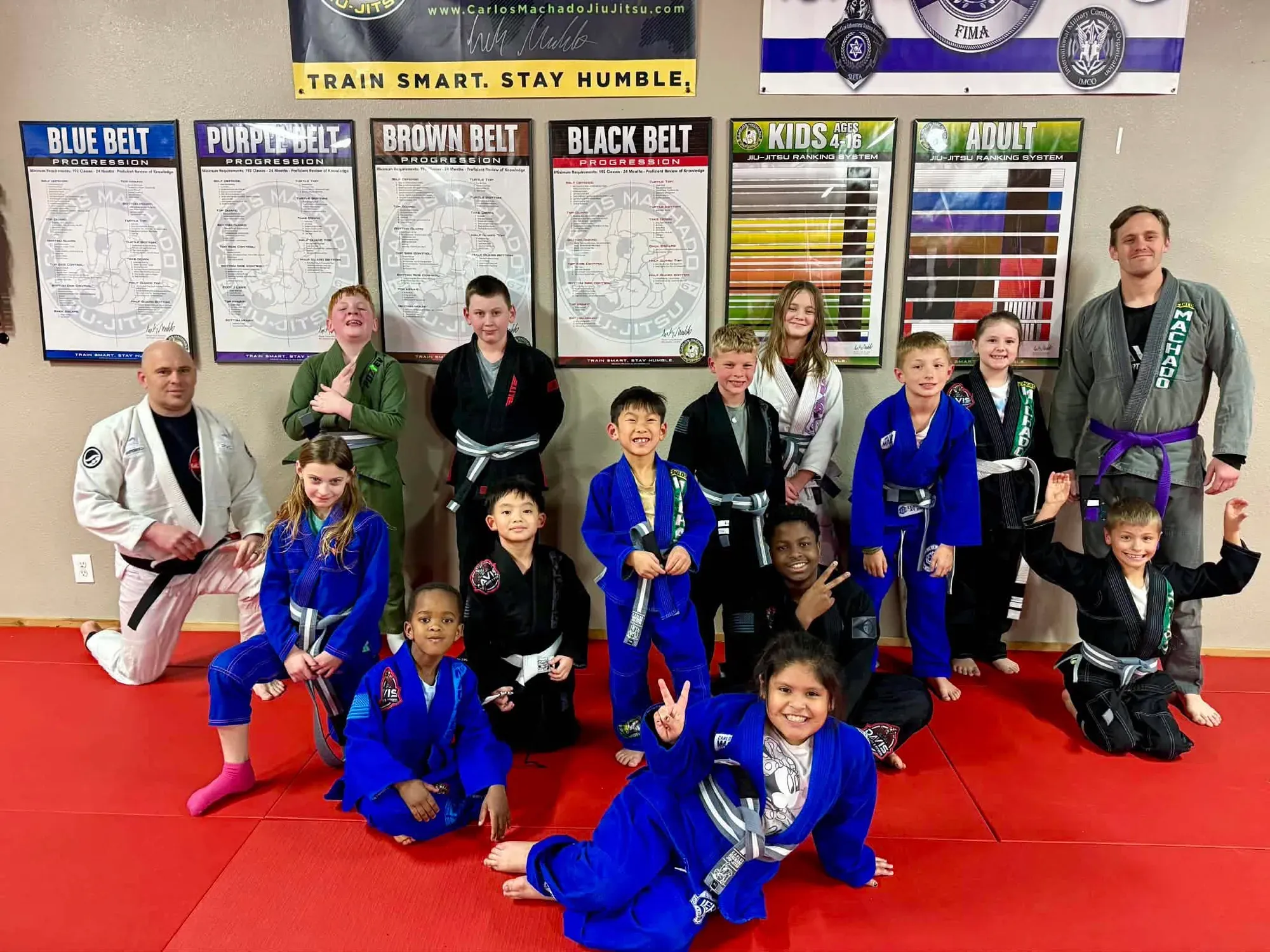The kids Brazilian Jiu-Jitsu class together on the red mats after training at Davis Martial Arts & Fitness in Pilot Point, TX