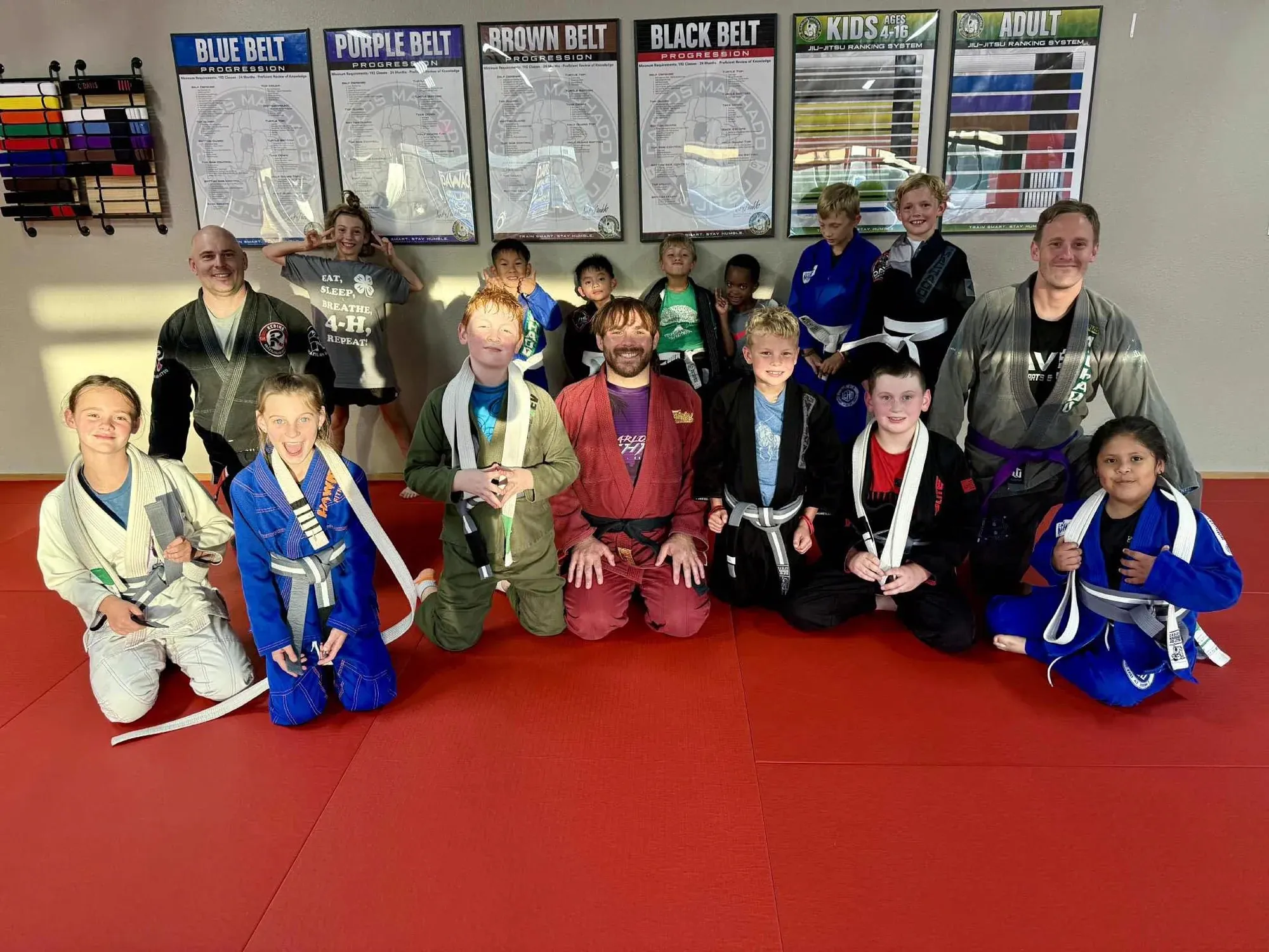 Group photo of students of all ages and ranks with instructors inside Davis Martial Arts & Fitness in Pilot Point, TX