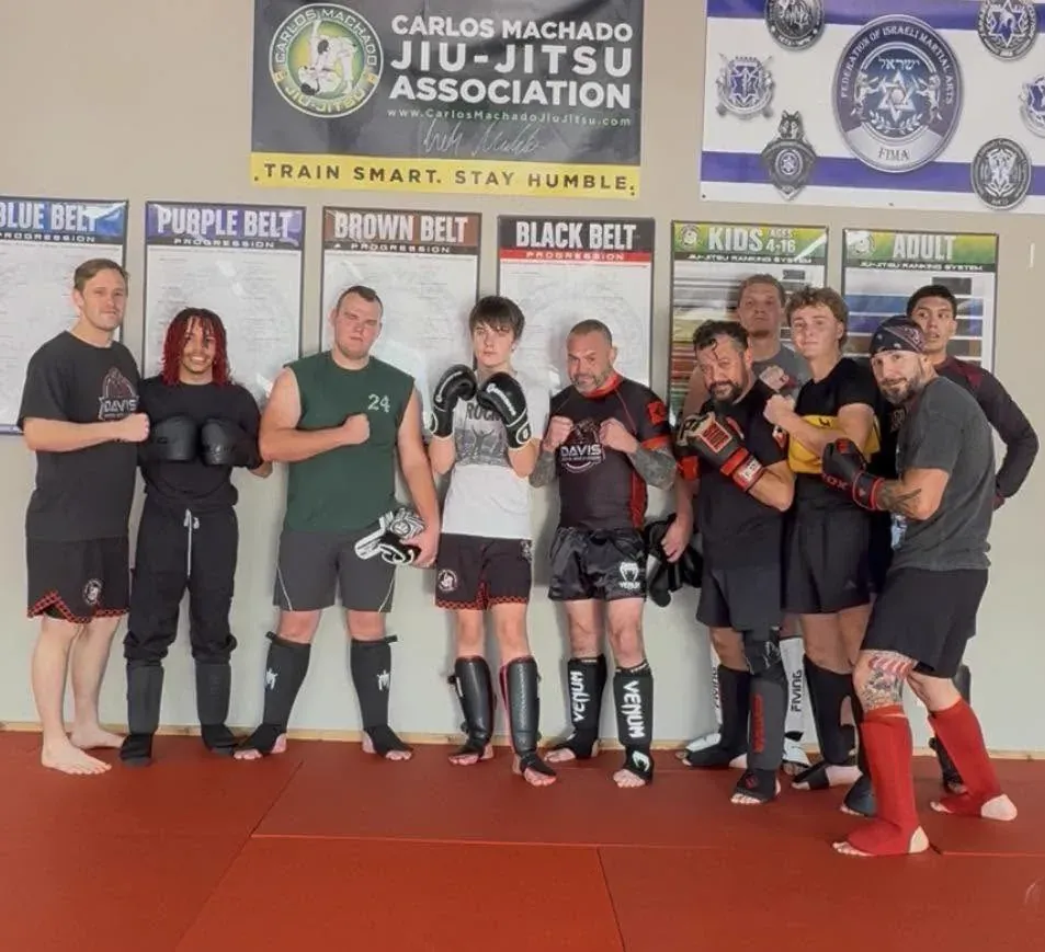 Adults in shin guards and gloves after training at Davis Martial Arts & Fitness in Pilot Point, TX