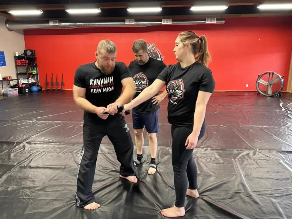 Instructor teaching a Krav Maga wrist-control technique to students at Davis Martial Arts & Fitness in Pilot Point, TX