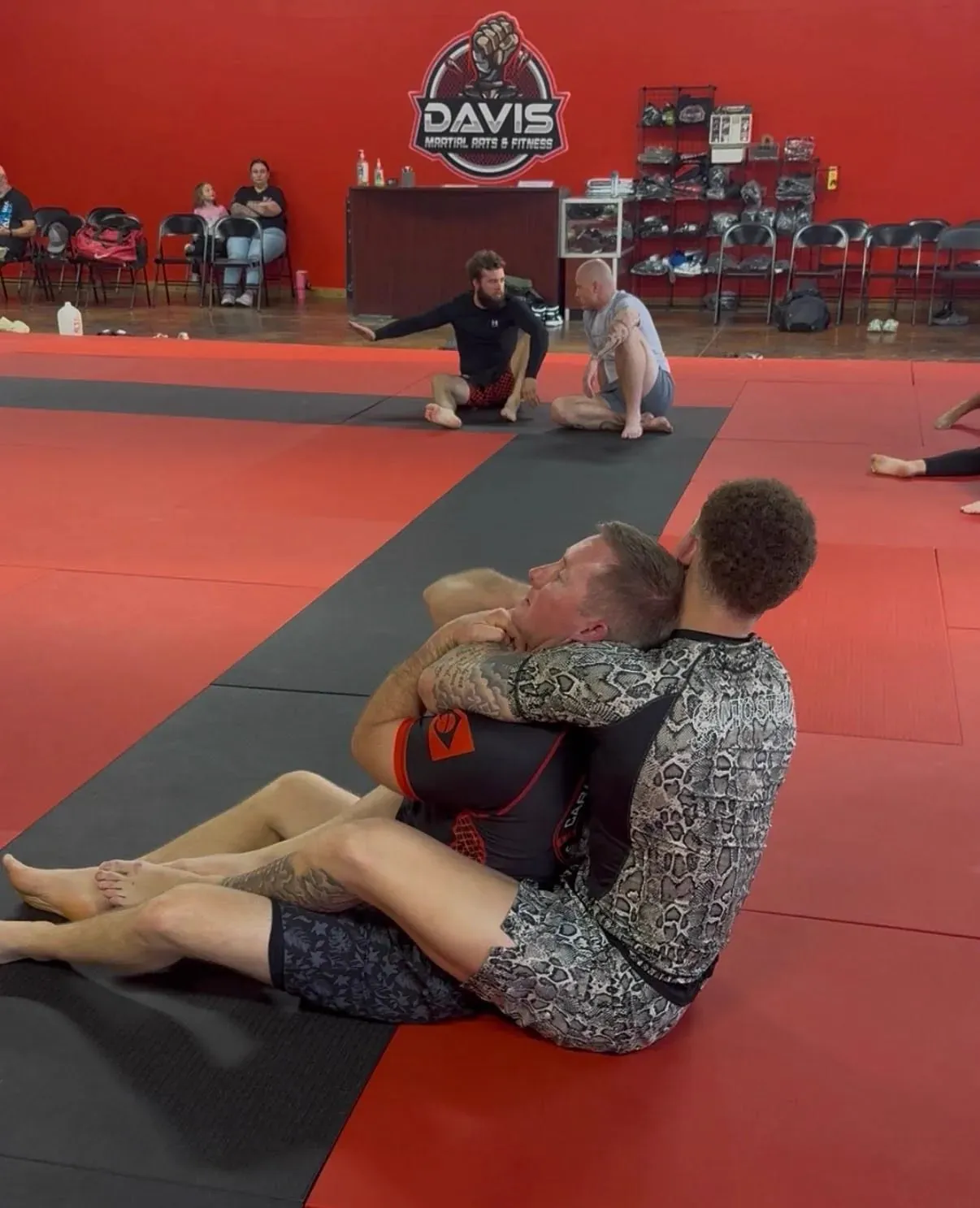 Young student practicing Brazilian Jiu-Jitsu with an instructor during class at Davis Martial Arts & Fitness in Pilot Point