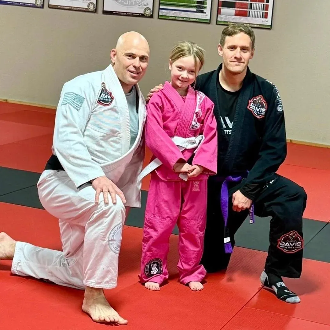 Young students lined up with fists raised after a belt ceremony at Davis Martial Arts & Fitness in Pilot Point