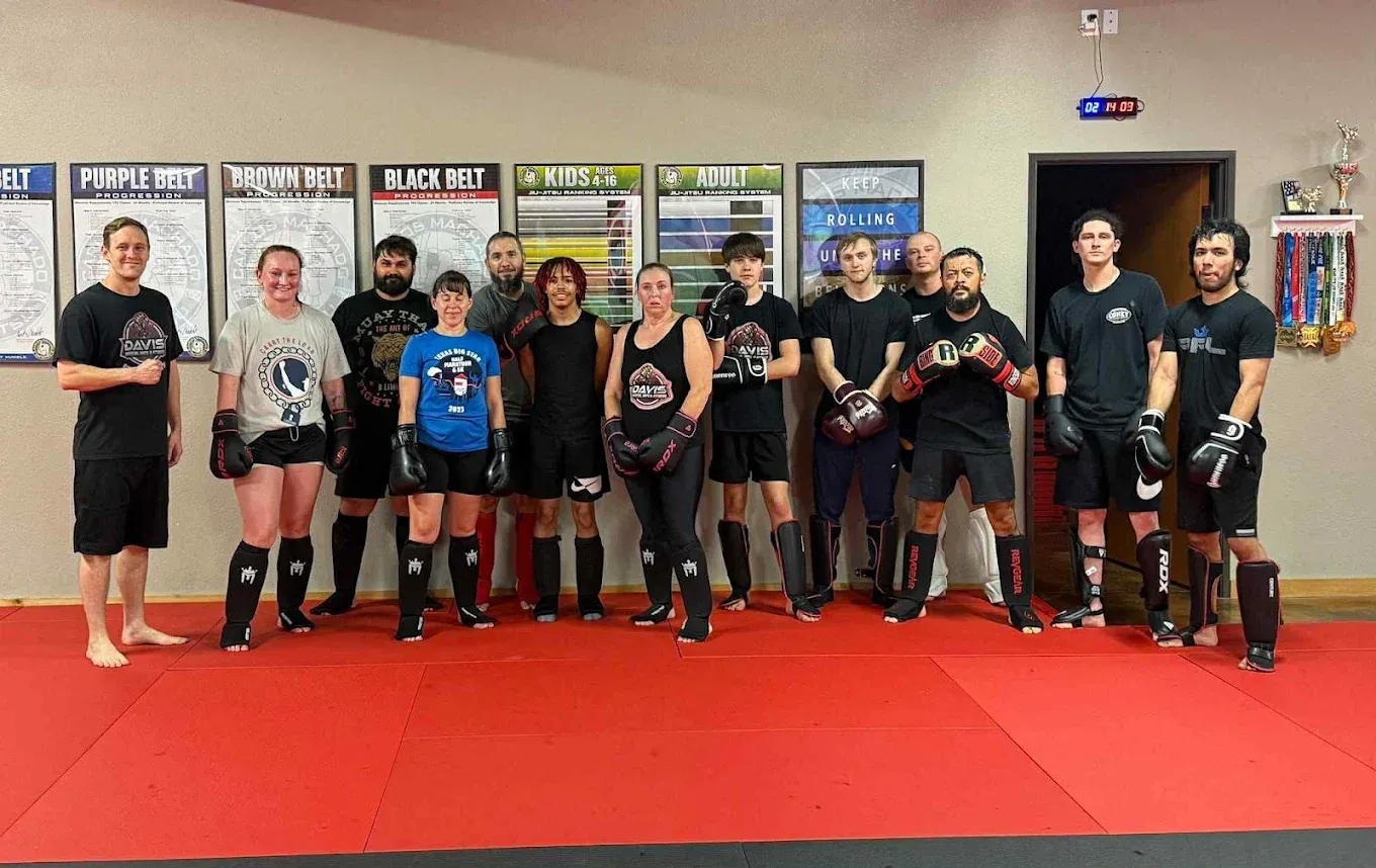 The kickboxing class lined up in boxing gloves and shin guards after training at Davis Martial Arts & Fitness in Pilot Point, TX