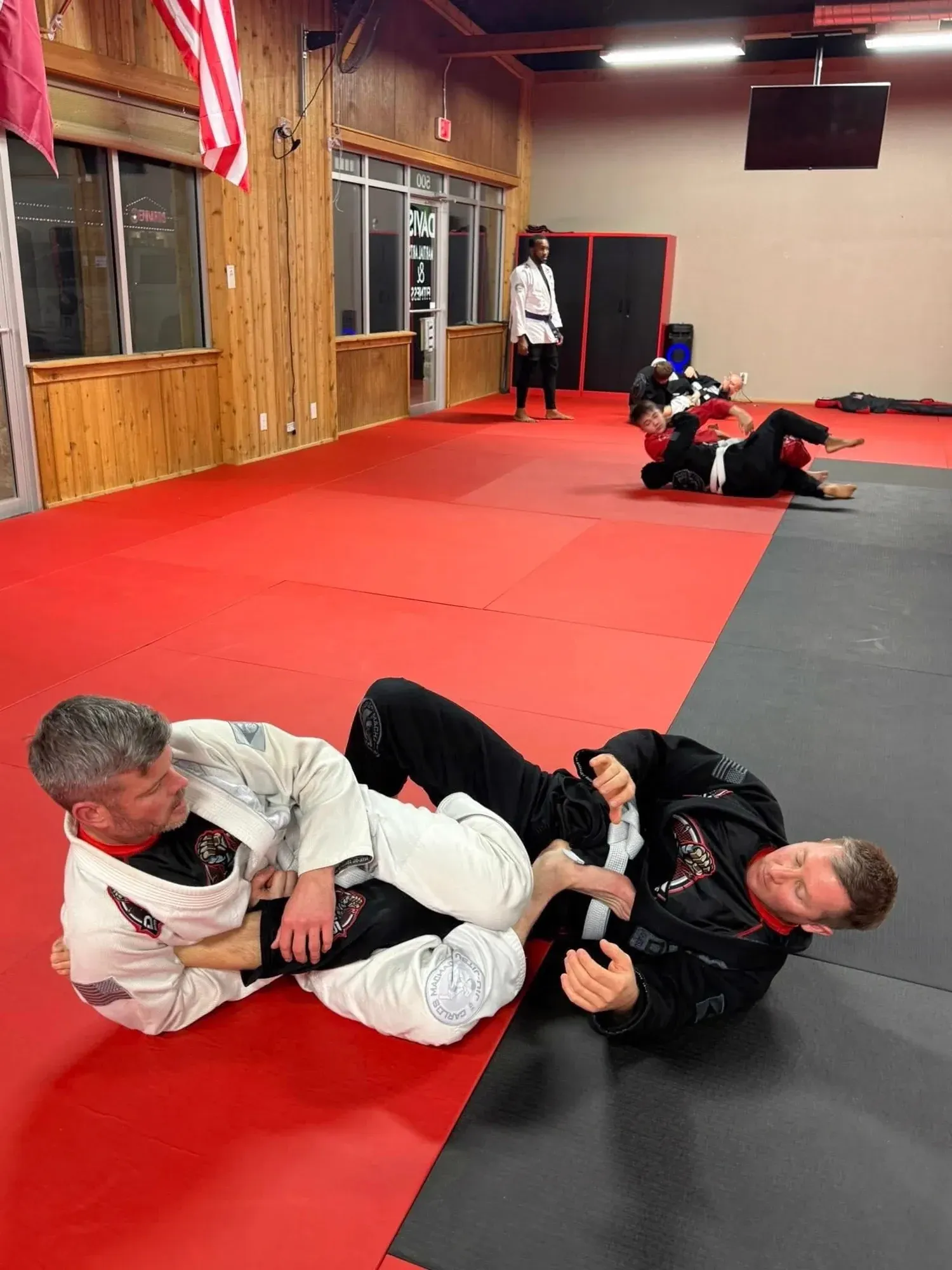 Two adult BJJ students in gis training together at Davis Martial Arts & Fitness in Pilot Point