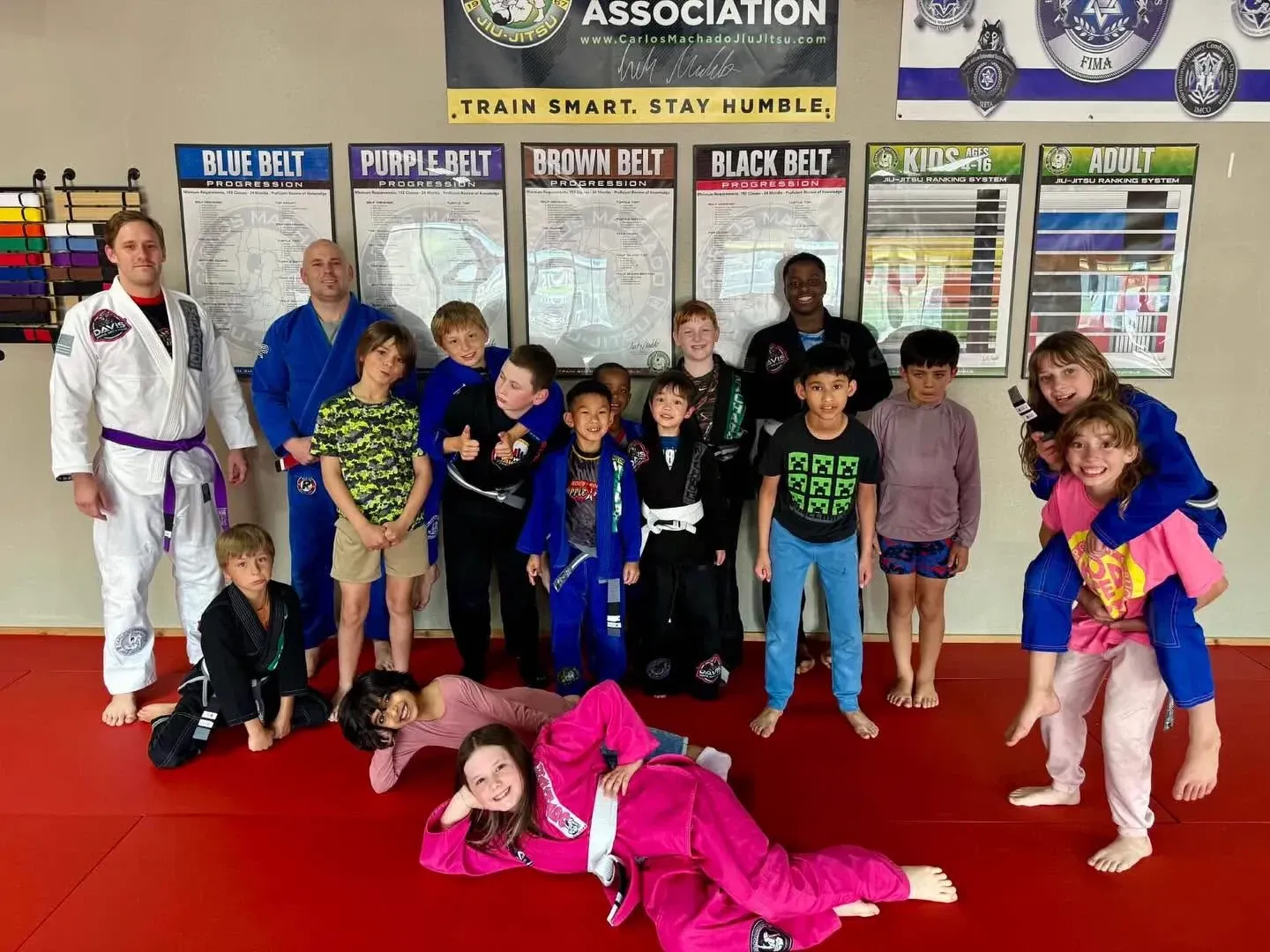 Young Kids BJJ students in gis training with a coach at Davis Martial Arts & Fitness in Pilot Point